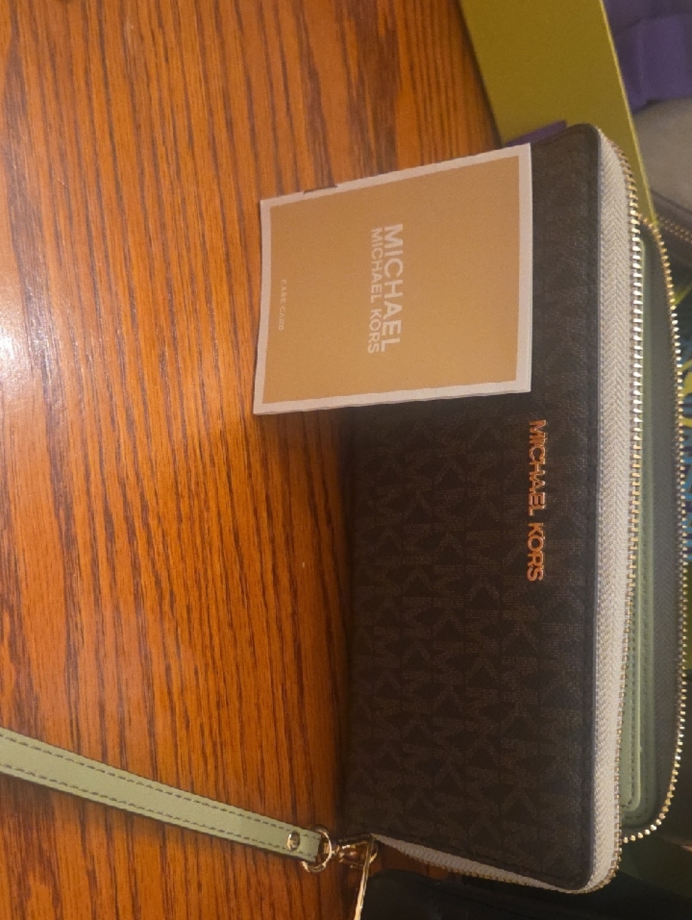 Michael Kors Dark Brown Logo Wristlet with Pale Green Strap